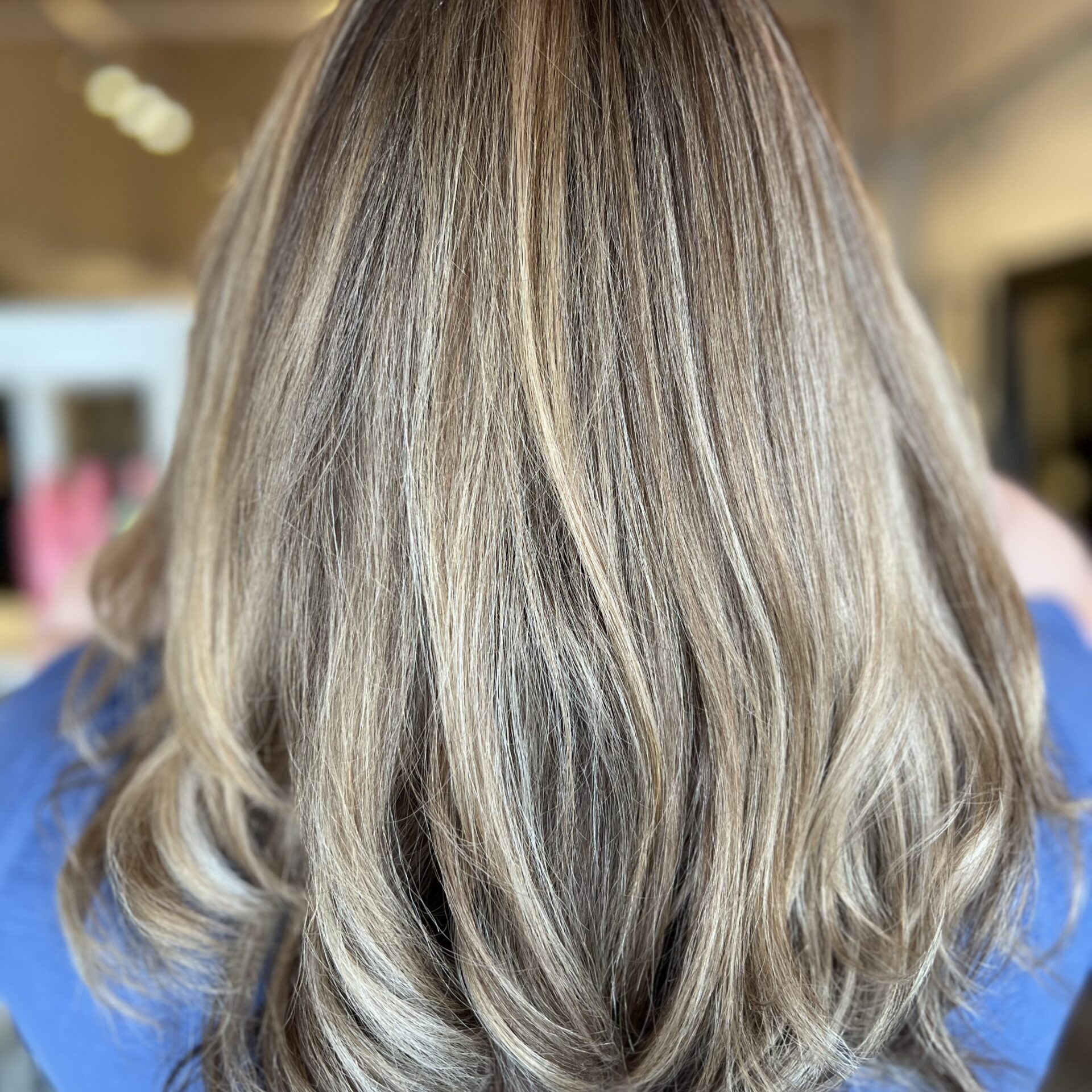 Back view of highlighted layered blonde hair